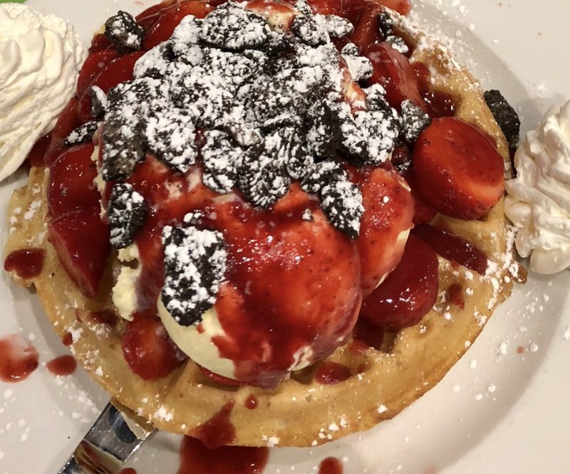 Belgian waffle topped with strawberries, Oreos and white chocolate ice cream
